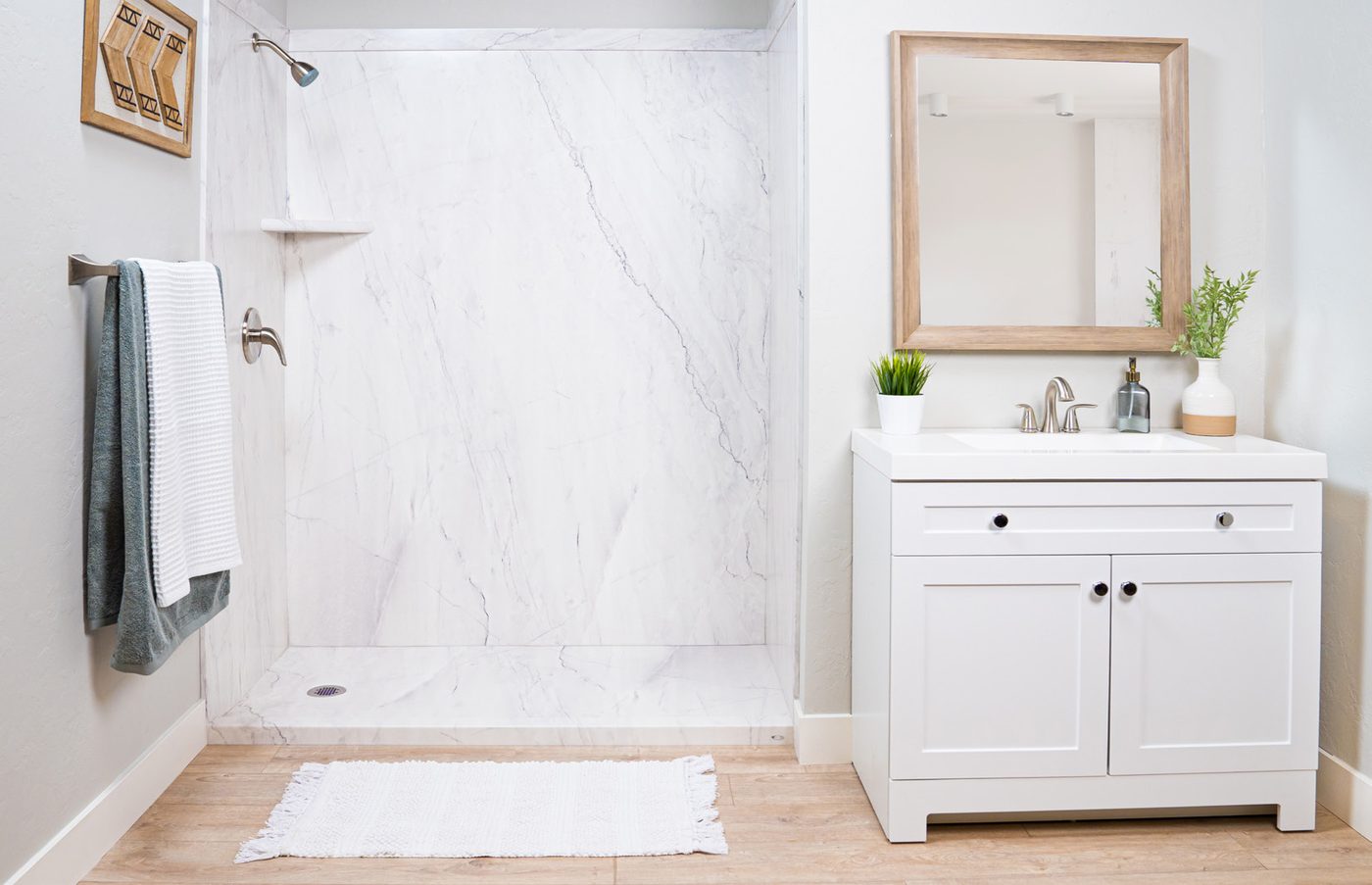 Marble walk-in shower paired with a white vanity